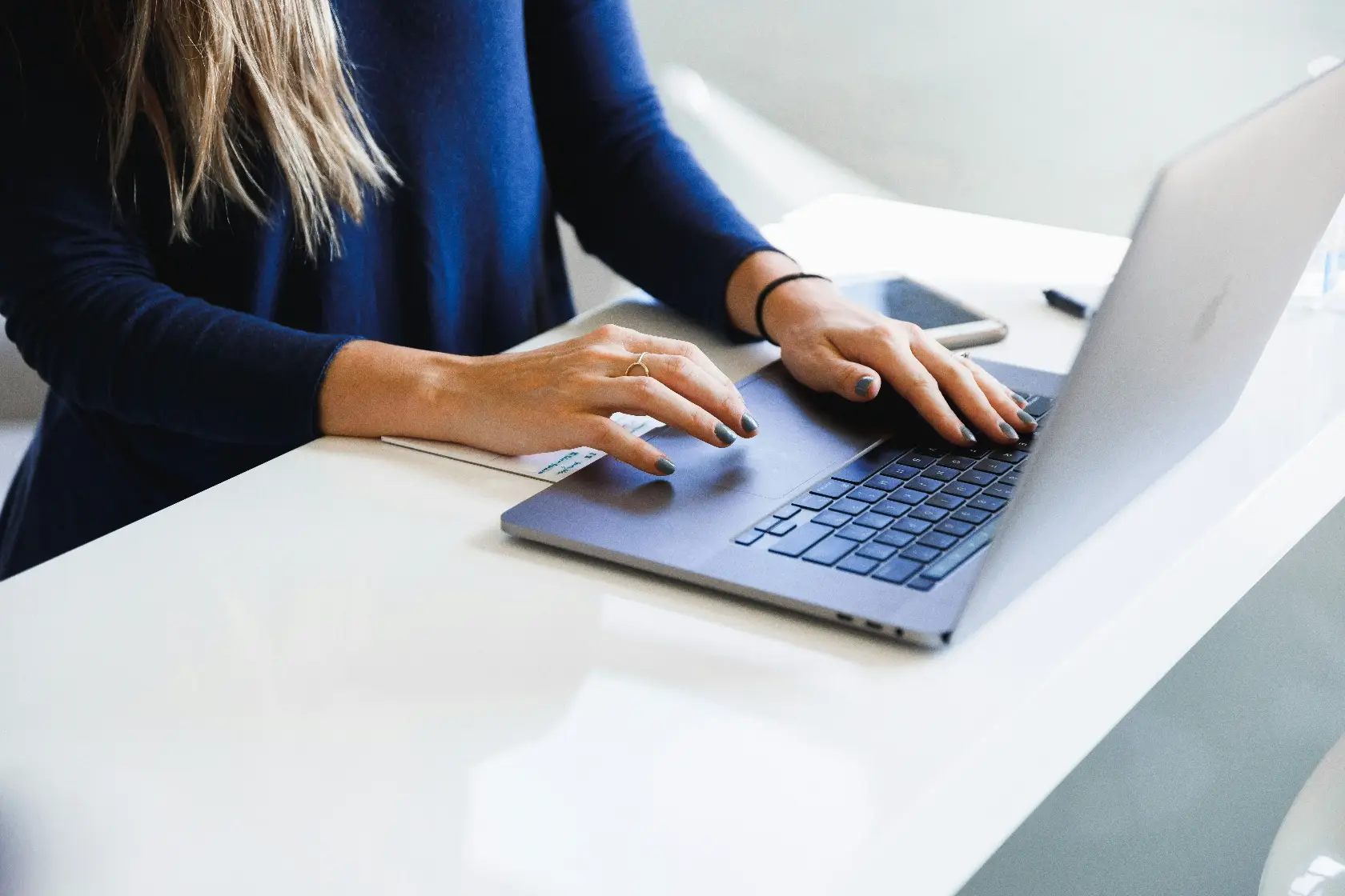 Close up of a person typing on a laptop